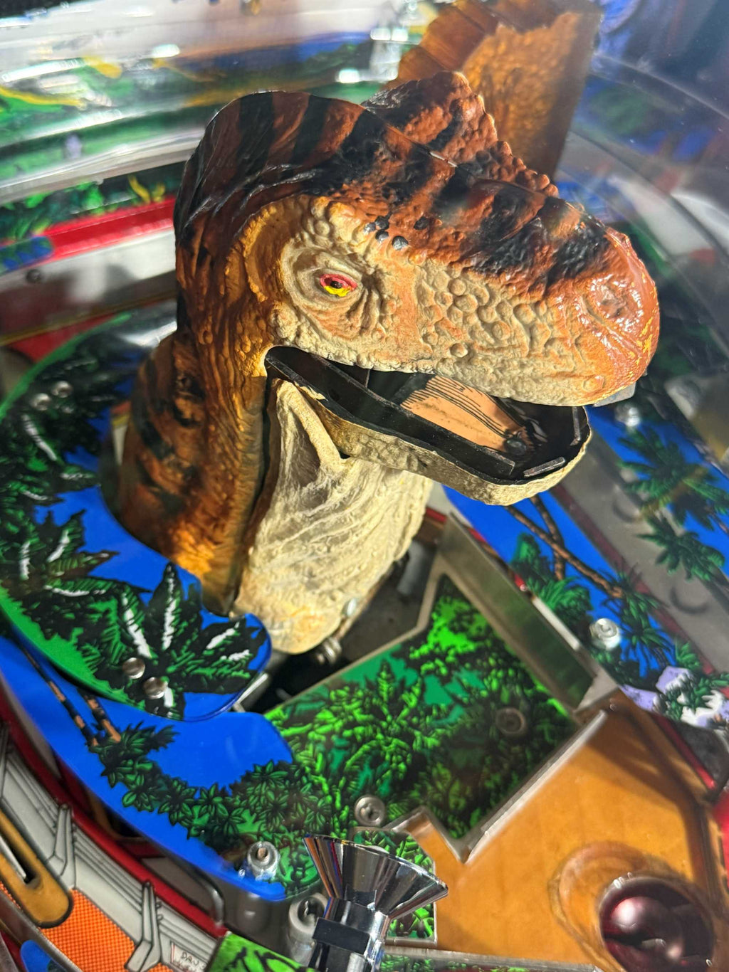 Moving Dinosaur figure on a pinball machine with colorful background